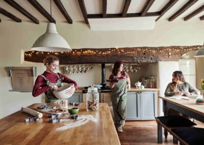The farmhouse kitchen at the Country Dog Hotel with people cooking around the island