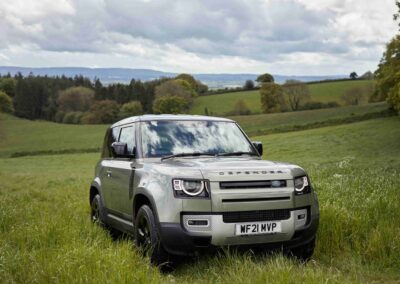 A Land Rover Defender parked in a field at the Country Dog Hotel