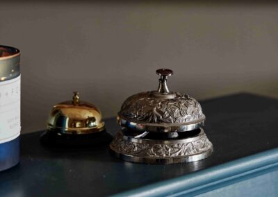 Two ornate reception bells on the front desk at the Country Dog Hotel