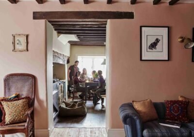 Guests and dogs relaxing in the warm, homely farmhouse sitting room and kitchen at the Country Dog Hotel